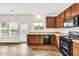 This home's kitchen features stainless appliances, hardwood floors, and a window with a view at 1530 Avalon Creek Rd, Sugar Hill, GA 30518