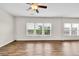 Bright living room features hardwood floors, lots of windows and ceiling fan at 1530 Avalon Creek Rd, Sugar Hill, GA 30518