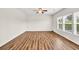 Bright living room features hardwood floors, ceiling fan, and lots of natural light at 1530 Avalon Creek Rd, Sugar Hill, GA 30518
