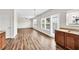 Open-concept living area with hardwood floors, a ceiling fan, and a view of the yard at 1530 Avalon Creek Rd, Sugar Hill, GA 30518