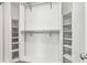 Spacious walk-in closet features shelving and hanging rods to maximize storage space at 1530 Avalon Creek Rd, Sugar Hill, GA 30518