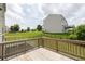 Backyard deck features wood railings and offers views of a manicured lawn and fenced perimeter at 1530 Avalon Creek Rd, Sugar Hill, GA 30518