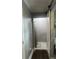 Hallway view of bathroom with shower, gray walls, dark floors, and white trim at 2225 Baker Nw Ter, Atlanta, GA 30318