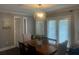 Stylish dining room with modern light fixture, wood table, and plenty of natural light at 2225 Baker Nw Ter, Atlanta, GA 30318