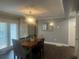 Warm dining room with a wood table, stylish lighting, and french doors bringing in light at 2225 Baker Nw Ter, Atlanta, GA 30318
