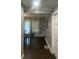 Neutral hallway and open dining room with natural light from the window, with a door to the right at 2225 Baker Nw Ter, Atlanta, GA 30318