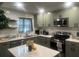 Modern kitchen featuring sage green cabinets, stainless steel appliances, and white countertops at 2225 Baker Nw Ter, Atlanta, GA 30318