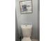 Standard white toilet under wall art in a bathroom at 2225 Baker Nw Ter, Atlanta, GA 30318