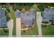 Birds eye view of a home showcasing its manicured lawn, driveway, and architectural roof design at 3468 Aberrone Pl, Buford, GA 30519