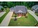 Aerial view displays a single-story brick home and lush yard at 3468 Aberrone Pl, Buford, GA 30519