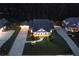 An aerial view showcases a home, its driveway, and manicured landscaping at twilight at 3468 Aberrone Pl, Buford, GA 30519
