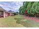 Expansive backyard with lush lawn, mature trees, and manicured landscaping, perfect for outdoor living at 3468 Aberrone Pl, Buford, GA 30519