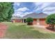 A spacious backyard with a lush lawn and a well-maintained brick exterior of the home at 3468 Aberrone Pl, Buford, GA 30519