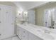 Bright bathroom features a double sink vanity with a large mirror and white cabinets and trim at 3468 Aberrone Pl, Buford, GA 30519