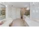 Bright Primary bath featuring large soaking tub, double sinks, vanity, and glass enclosed shower at 3468 Aberrone Pl, Buford, GA 30519