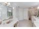 Bright Primary bath featuring large soaking tub, double sinks, vanity, and glass enclosed shower at 3468 Aberrone Pl, Buford, GA 30519
