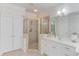 Elegant bathroom featuring a glass shower, double vanity, and decorative wallpaper at 3468 Aberrone Pl, Buford, GA 30519
