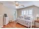 Bedroom featuring hard wood floors, plantation shutters and TV at 3468 Aberrone Pl, Buford, GA 30519