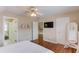 Bright bedroom with hardwood floors, ample natural light, ceiling fan, and access to other rooms at 3468 Aberrone Pl, Buford, GA 30519