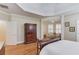 Large bedroom featuring tray ceilings, hardwood floors, shuttered windows, and sitting area at 3468 Aberrone Pl, Buford, GA 30519