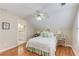 Cozy bedroom features a ceiling fan, hardwood floors, and an ensuite bathroom at 3468 Aberrone Pl, Buford, GA 30519