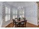 Charming breakfast room with blue and white patterned wallpaper, chandelier, and plantation shutters at 3468 Aberrone Pl, Buford, GA 30519