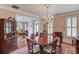 Elegant dining room with hardwood floors, chandelier, and ample seating for gatherings at 3468 Aberrone Pl, Buford, GA 30519
