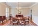 Formal dining room featuring hardwood floors, a chandelier, and wainscoting at 3468 Aberrone Pl, Buford, GA 30519
