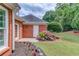 Charming exterior detail with blooming hydrangeas, brick accents, and well-maintained landscaping at 3468 Aberrone Pl, Buford, GA 30519