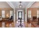 Open foyer with hardwood floors, decorative table, and access to formal living areas at 3468 Aberrone Pl, Buford, GA 30519