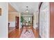 Elegant foyer with hardwood floors, chandelier, and decorative rug leading to living spaces at 3468 Aberrone Pl, Buford, GA 30519