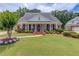 Charming single-story brick home with a columned front porch and a beautifully landscaped front yard at 3468 Aberrone Pl, Buford, GA 30519