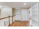 Upstairs hallway with wood floors, white railings, built-in shelves, and access to additional rooms at 3468 Aberrone Pl, Buford, GA 30519
