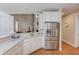 Kitchen featuring white cabinets, granite countertops, stainless steel appliances, and access to living area at 3468 Aberrone Pl, Buford, GA 30519