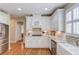 Bright eat-in kitchen featuring white cabinets, granite countertops, stainless steel appliances, and hardwood floors at 3468 Aberrone Pl, Buford, GA 30519