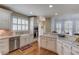 Lovely kitchen with white cabinets, granite countertops, stainless steel appliances and a decorative kitchen rug at 3468 Aberrone Pl, Buford, GA 30519