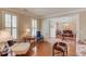 Stylish living room with hardwood floors, natural light, and open access to dining area at 3468 Aberrone Pl, Buford, GA 30519
