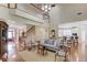 Open floor plan with hardwood floors, living room, staircase, and views into the kitchen at 3468 Aberrone Pl, Buford, GA 30519