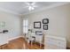 Functional office space with hardwood floors, built-in storage, and natural lighting at 3468 Aberrone Pl, Buford, GA 30519