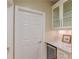 Convenient pantry area with built-in wine cooler, marble countertop, and glass-front cabinets at 3468 Aberrone Pl, Buford, GA 30519