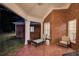 Covered brick patio with chaise lounge and chair, perfect for relaxing outdoors at 3468 Aberrone Pl, Buford, GA 30519