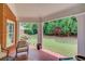 Covered brick patio with green lawn, trees, and garden views at 3468 Aberrone Pl, Buford, GA 30519