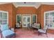 Large covered brick patio with furniture and backyard views at 3468 Aberrone Pl, Buford, GA 30519