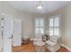 Bedroom sitting area featuring two large shuttered windows and two plush armchairs with ottoman at 3468 Aberrone Pl, Buford, GA 30519