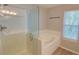 Bathroom featuring a glass-enclosed shower, soaking tub, and modern fixtures at 4149 Spring Cove Dr, Duluth, GA 30097