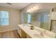 Bathroom featuring dual sinks, a large mirror, and a spacious vanity area at 4149 Spring Cove Dr, Duluth, GA 30097
