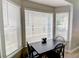 Bright breakfast nook with a table set by large windows, creating a cozy and inviting dining space at 4149 Spring Cove Dr, Duluth, GA 30097