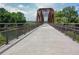Wide shot of the walking bridge with greenery on both sides at 4149 Spring Cove Dr, Duluth, GA 30097