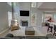 Spacious living room with a fireplace, tall windows, and a view to the kitchen, perfect for entertaining at 4149 Spring Cove Dr, Duluth, GA 30097