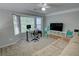 Cozy living room with large windows, plush carpet, and entertainment center at 4149 Spring Cove Dr, Duluth, GA 30097